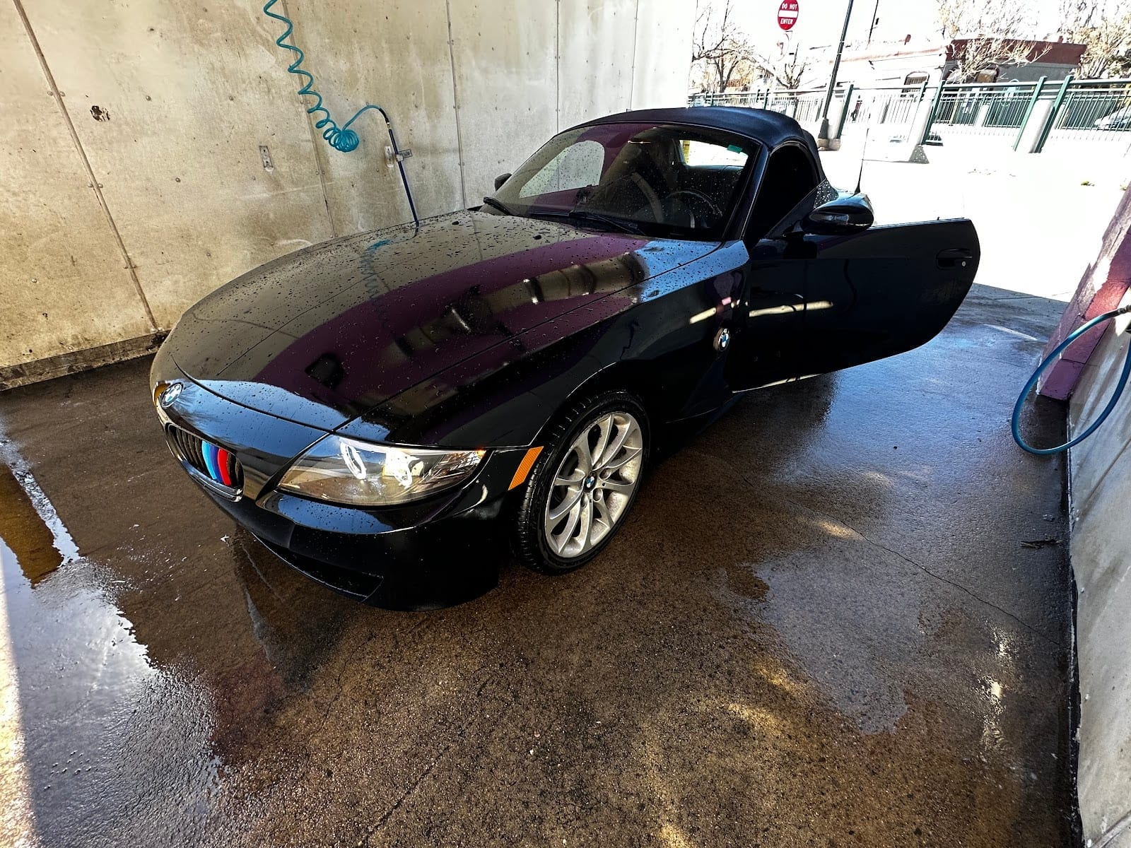 Black BMW Z4 convertible, freshly washed after bodywork