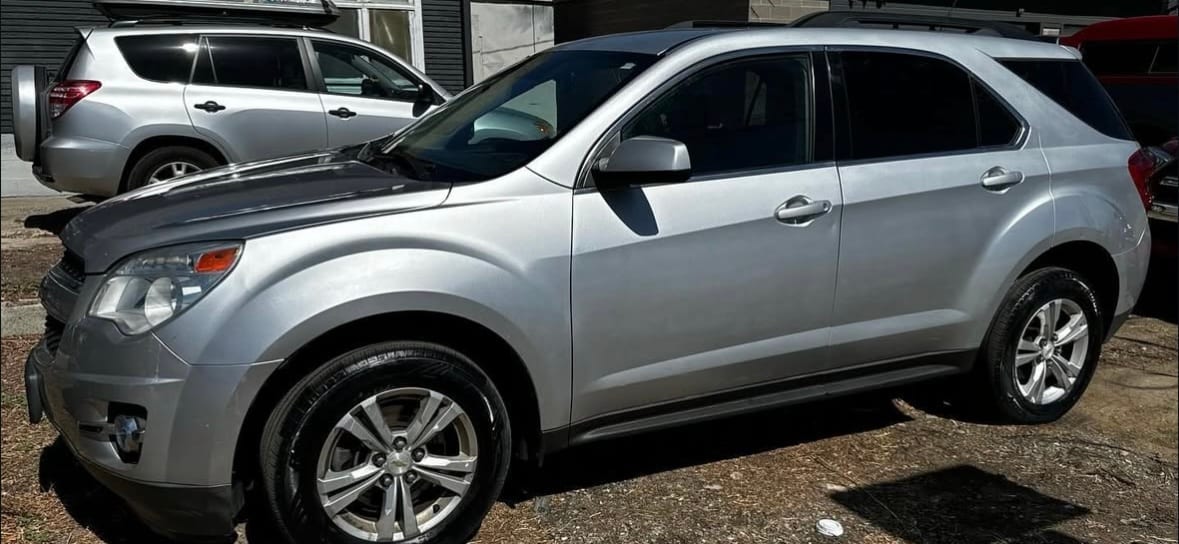 Silver Chevrolet Equinox outside the shop