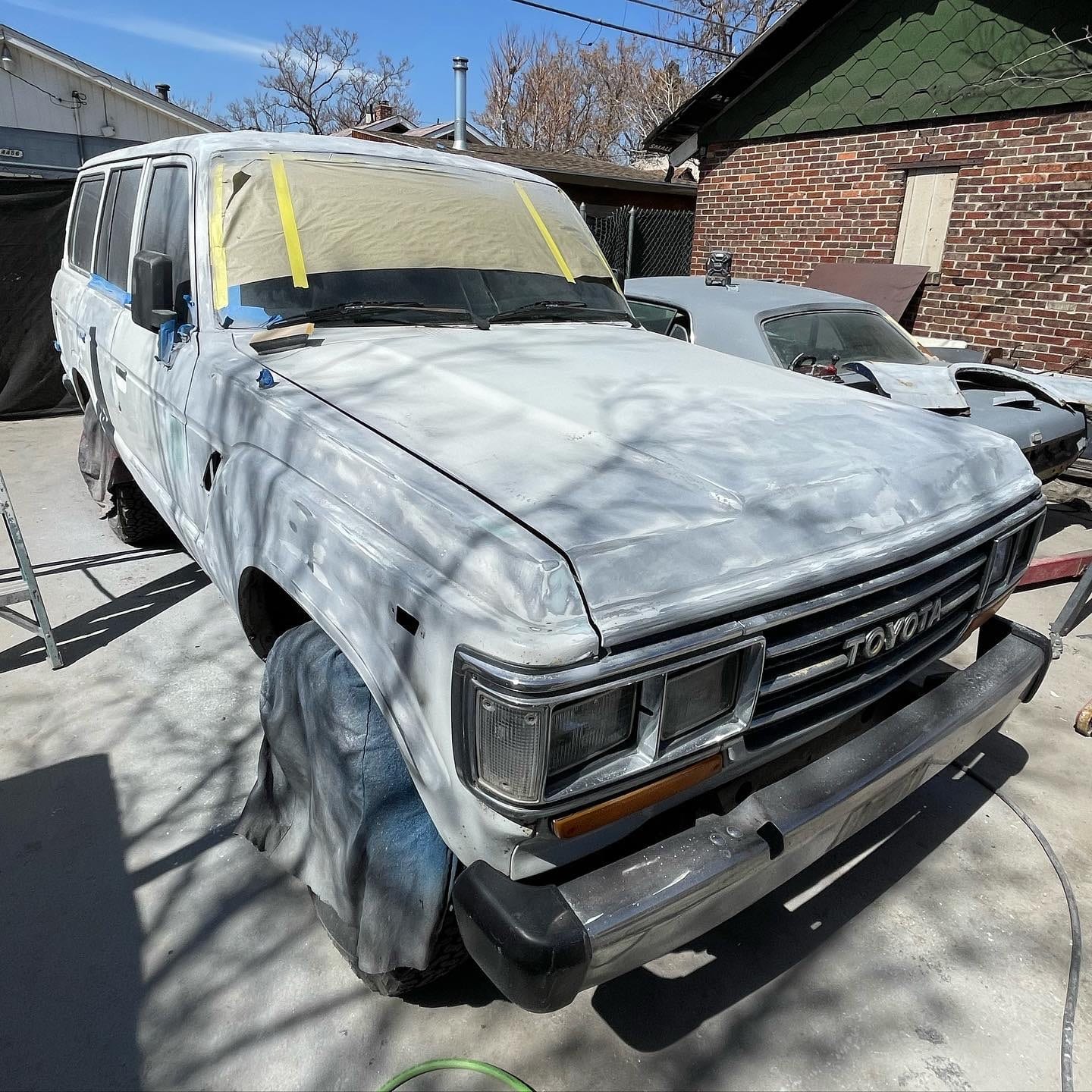 Toyota Land Cruiser in grey primer and masked for paint